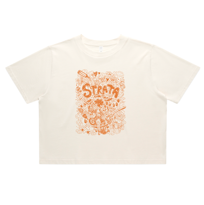 An off-white short-sleeve crop top t-shirt featuring a prominent orange graphic print on the front with the word 'STRATA' and dreamy doodles, displayed flat against a white background.